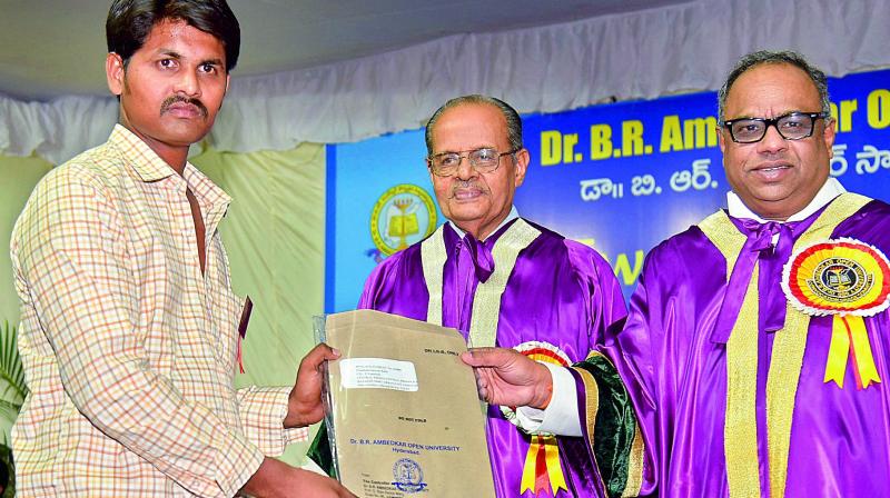 Satyam Babu receives his certificate from National University of Educational Planning and Administration Chancellor N.R. Madhava Menon on Monday. (Photo:DC)