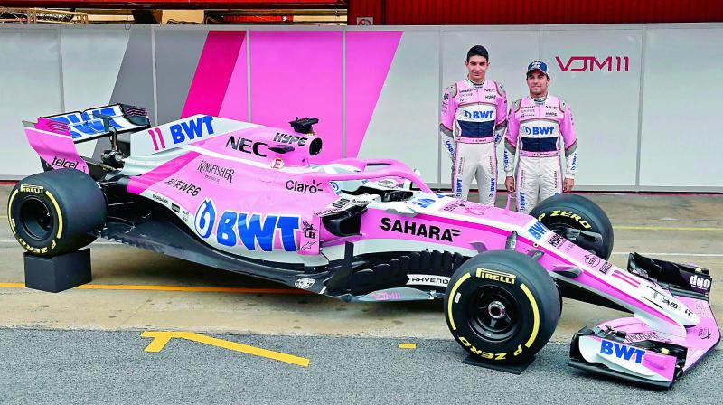 Force Indias drivers Sergio Perez (right) and Esteban Ocon pose by their new VJM11 car during the official presentation at the Circuit de Catalunya on Monday in Montmelo, Barcelona, during the first test day of the Formula One Grand Prix season. (Photo: AFP)