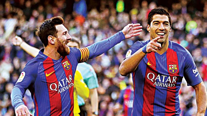 Barcelonas Luis Suarez (right) celebrates with teammate Lionel Messi after scoring against Las Palmas (Photo: AFP)