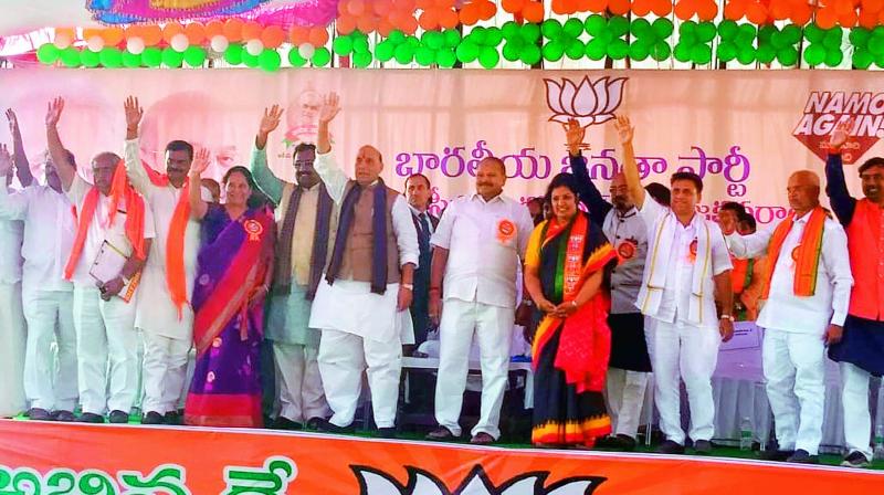 Union home minister Rajnath Singh and other BJP leaders wave to the crowd during the Rayalaseema-level Shakti Groups meeting at Kadapa on Friday. (Photo: DC)