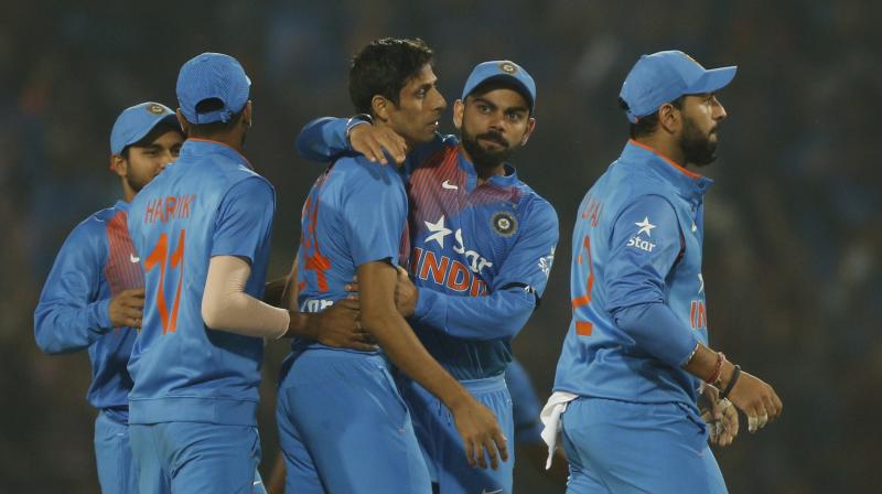 While Jasprit Bumrah held his nerve as England needed 8 runs in the final over to win Nagpur T20, Ashish Nehra scalped three wickets and played his part in Indias five-run win over England in Nagpur T20. (Photo: AP)