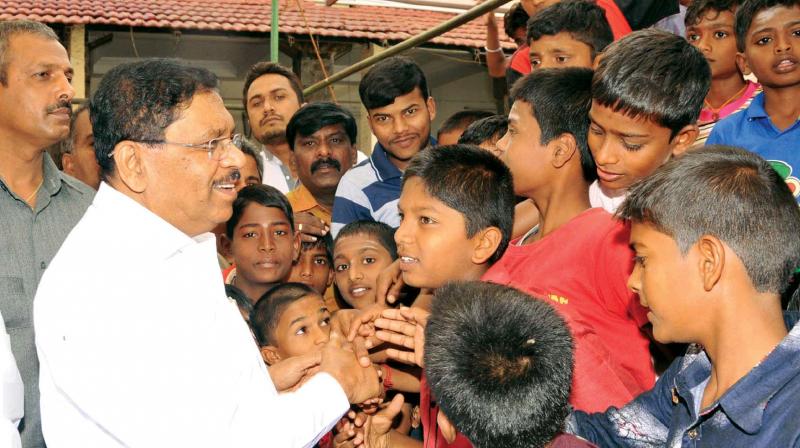 KPCC president Dr G. Parameshwar with children at Sri Shivakumara Swamis Siddaganga Math in Tumakuru on Friday   KPN