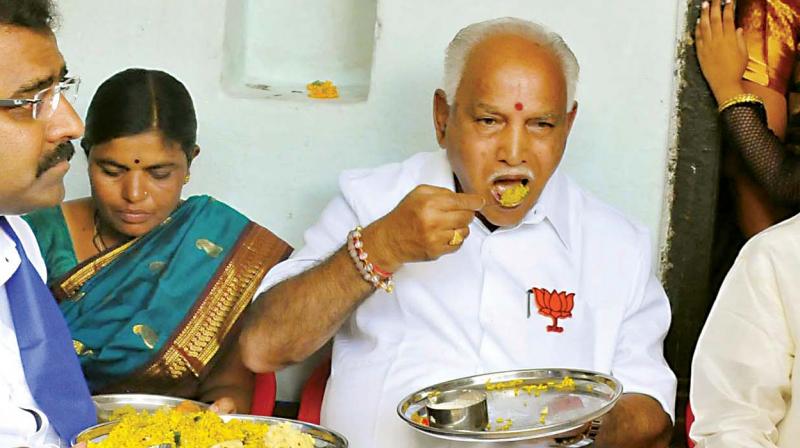 State BJP president B.S. Yeddyurappa having breakfast at a Dalits house at Hudagi village in Humnabad taluk on Friday  (Photo:KPN)