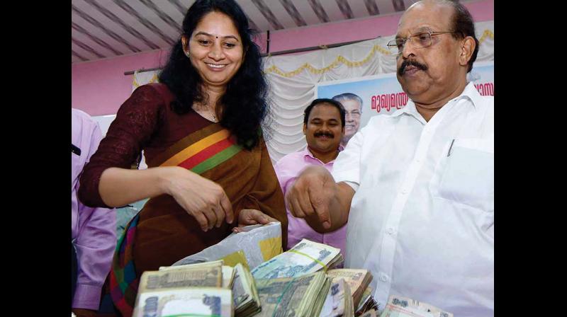 PWD minister G. Sudhakaran and U. Prathiba, MLA, during constituency-based fund collection drive held as part of re-building Kerala in Alapuzha on Friday.(Photo:DC)