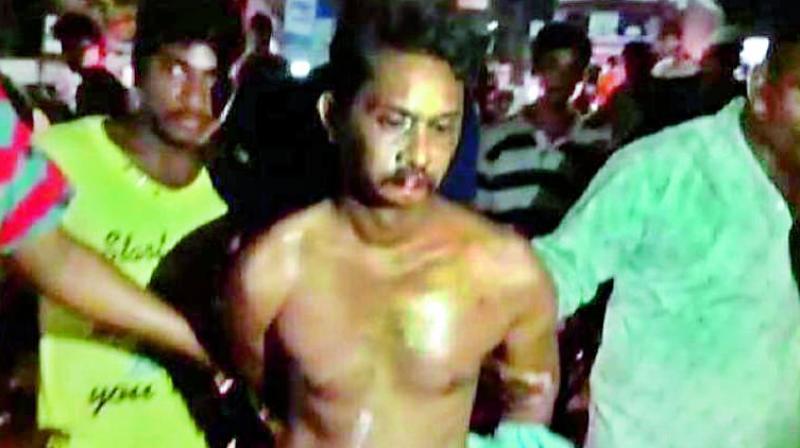 The English teacher, Rambabu, being paraded naked for impregnating a girl.  (Image: DC)