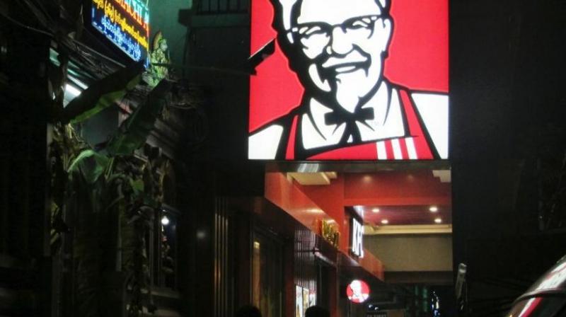 A sign of KFCs grinning Colonel Sanders and his goatee is lit outside its outlet in Yangon, Myanmar. (Photo: AP)