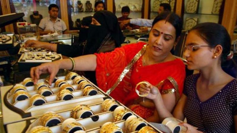 Women check out gold bangles at a jewellery shop. (Photo: PTI)