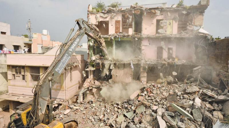 Greater Chennai corporation demolishing the building in Vadapalani where a fire accident occurred recently.  (Photo: DC)