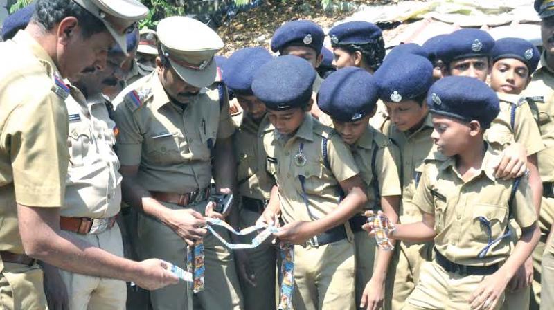 Student Police Cadets along with police checking seized tobacco products in Kochi on Friday.(Photo: DC)