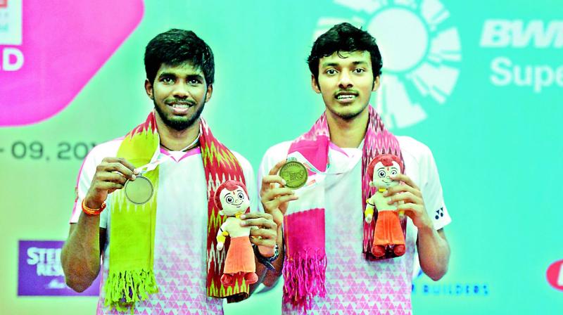 Gold medallists Satwiksairaj Rankireddy (left) and Chirag Shetty are all smiles as they pose with their medals after emerging champions in the mens doubles final at the Hyderabad Open badminton tournament in Hyderabad on Sunday. 	  (Image: AFP)