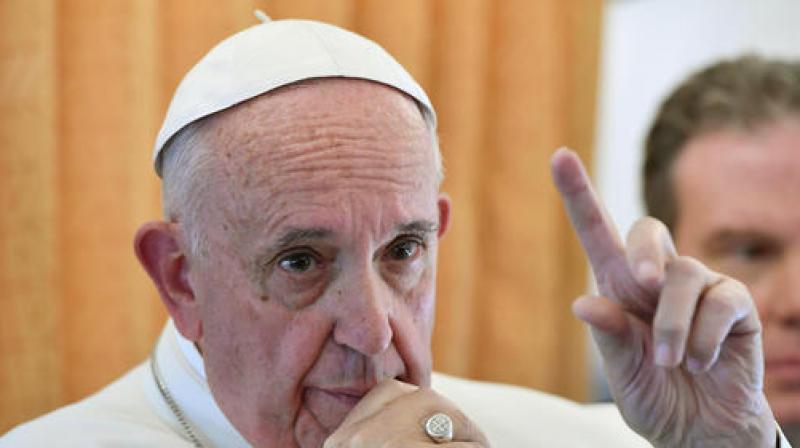 Pope Francis talks to reporters on his flight back from Sweden. (Photo: AP)
