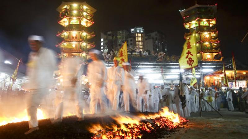 Malaysia: Men walk over a bed of burning coal at Nine Emperor Gods festival