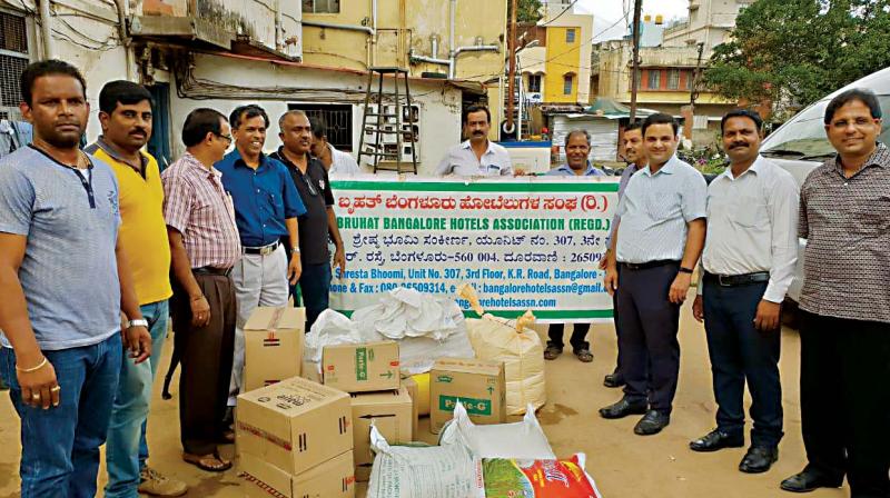 Representatives of Bangalore Tourist Taxi Owners Association and Bruhat Bengaluru Hotels Association dispatching 6 tonne relief materials to Kushalnagar on Saturday.