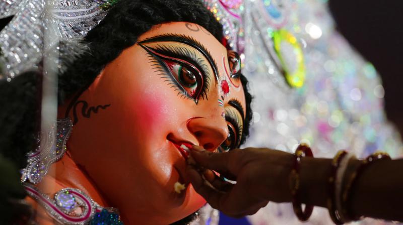 The immersion of idols marks the end of the festival that commemorates the slaying of a demon king by lion-riding, 10-armed goddess Durga, marking the triumph of good over evil. (Photos: AP/ PTI)