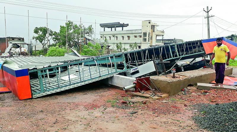 The roof of a petrol bunk collapses due to the devastation caused by the cyclone Titli at Kanchili in Srikakulam district on Thursday.(Photo: Murali Krishna)
