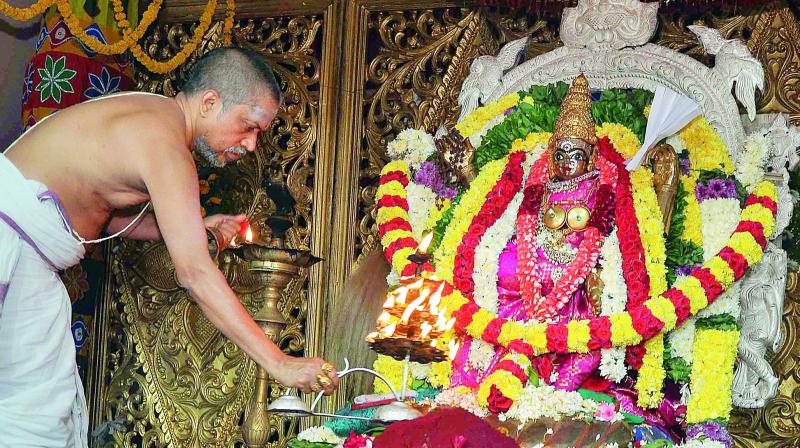 A priest offers kumbha harati to an idol of Goddess Kankadurga atop Indrakeeladri in Vijayawada on Thursday.