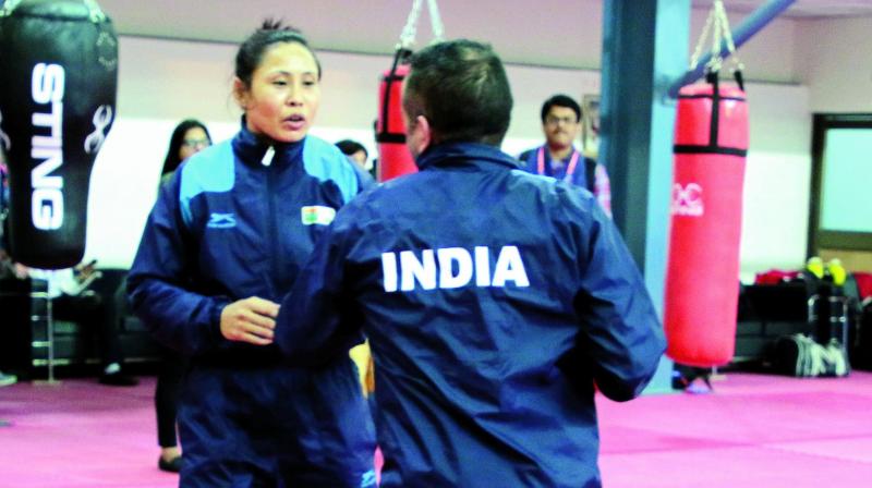 L. Sarita Devi (left) and Manisha Maun (right above) at a training session in New Delhi on Thursday.