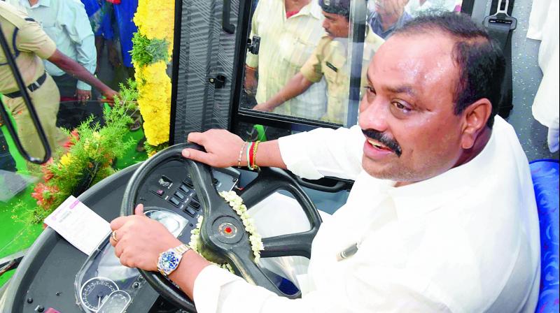 Transport minister K. Atchham Naidu drives the newly introduced Corona bus after launching it in Vijayawada on Friday.