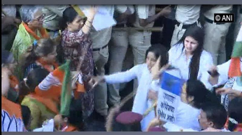 BJP workers organised a protest rally criticising the Congress leadership for raking up the Rafale deal issue near the state Congress headquarters. (Photo: ANI)