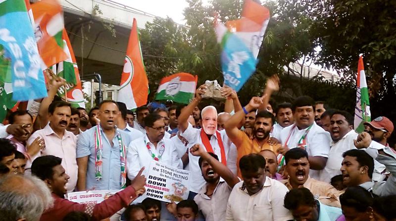 (Above) Congress workers led by KPCC president Dr G. Parameshwar and working president Dinesh Gundurao stage a protest at AR Circle in the city against the I-T raids on Energy Minister D.K. Shivakumar.