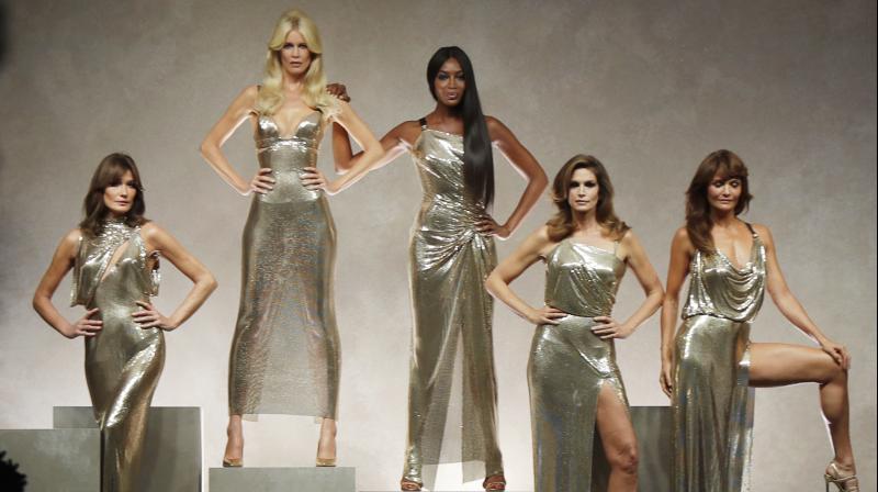 Carla Bruni, Claudia Shiffer, Naomi Campbell, Cindy Crawford and Helena Christensen wear a creations as part of the Versace womens Spring/Summer 2018 fashion collection, presented in Milan, Italy. (Photo: AP)