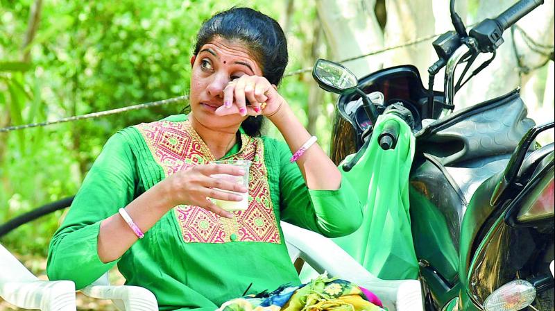 A mother wipes her tears after she managed to give her daughter a passport size picture at the last minute at an exam centre at Rishi Womens College in  Nizampet. 	 DC