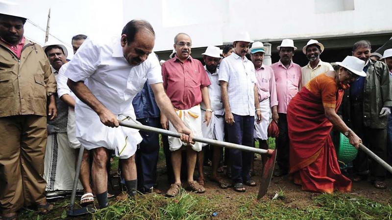 CPM state secretary Kodiyeri Balakrishnan heads the cleaning campaign by the partys district committee in Kozhikode on Wednesday. (Photo: Venugopal)