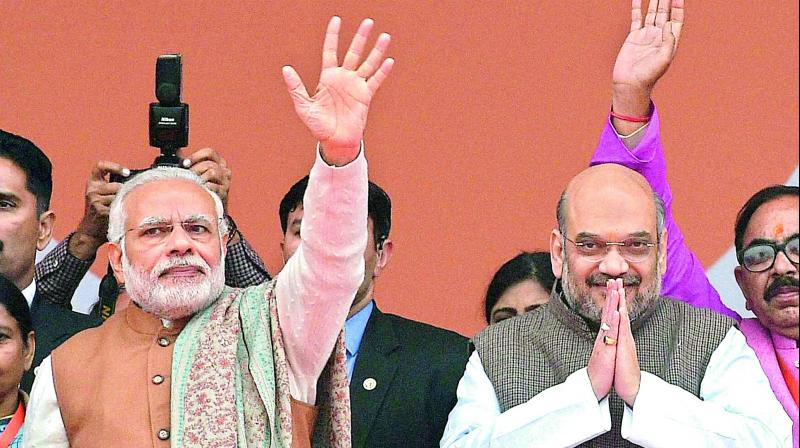Prime Minister Narendra Modi with BJP National President Amit Shah at the BJP Parivartan Rally in Lucknow on Monday. (Photo: PTI)