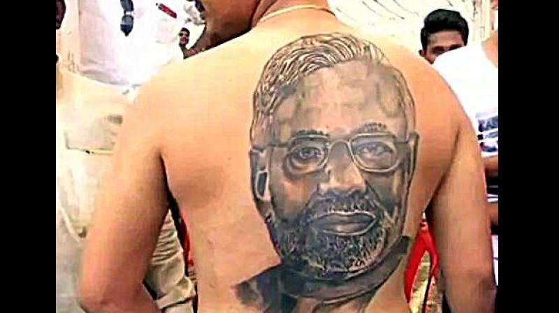 Karnataka Assembly election2018: A man in Raichur shows a tattoo of Prime Minister Narendra Modi on his back. (Photo: ANI | Twitter)