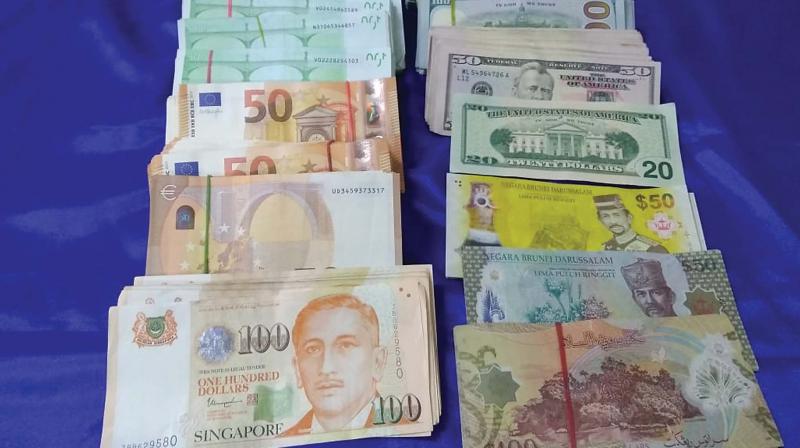 Apart from foreign currencies, Rs 4.6 lakh cash was found in his jacket pocket. Kalimuthu Natesaperumal, who was about to board a Singapore-bound flight, was arrested for further interrogation.
