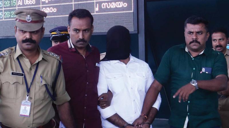 Police brings Mohammed Salih alias Ali Bhai out of Thiruvananthapuram airport on Tuesday. 	DC