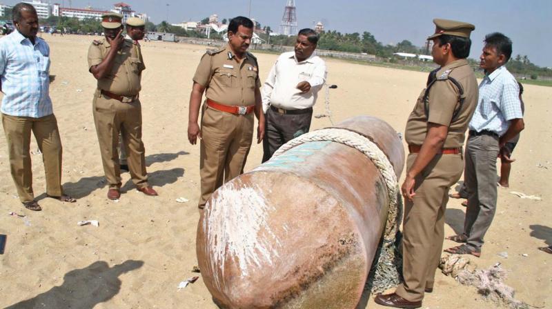 City police examine the buoy that washed ashore at Marina beach on Friday.	DC