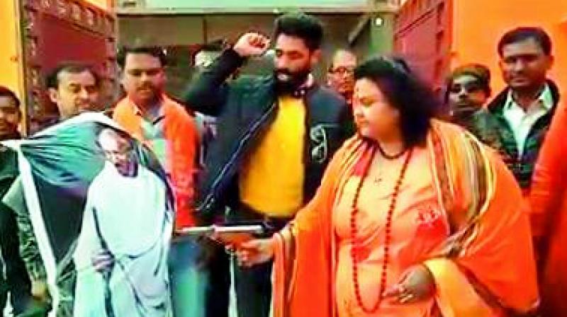 A woman leader of Hindu Mahasabha firing at an effigy of Mahatma Gandhi with an air pistol on Wednesday.