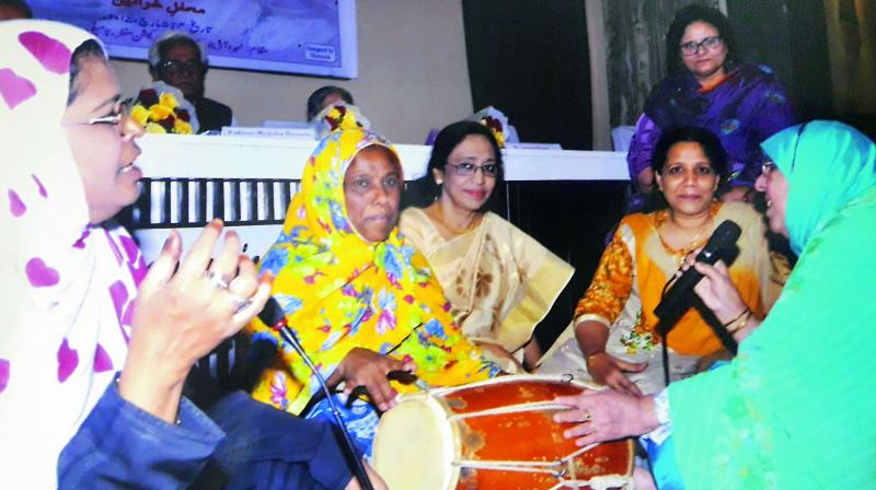 Mehfil members playing Dholak.