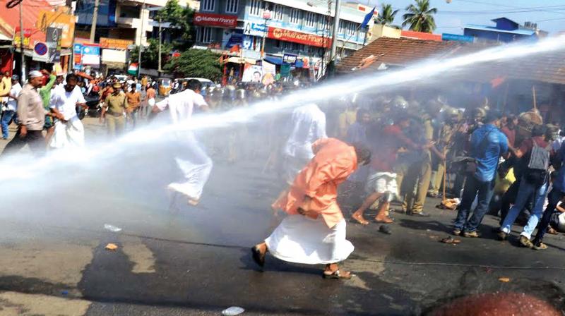 Police using water cannon against BJP activists who held a demonstration demanding  the resignation of Kerala Law Academy Law College Principal Lekshmy Nair at Peroorkada Junction in Thiruvananthapuram on Tuesday.(Photo: DC)