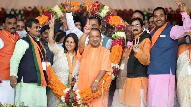 Uttar Pradesh Chief Minister Yogi Adityanath being garlanded by Bharatiya Janata Party workers during an election campaign rally for civic polls in Allahabad. (Photo: PTI)