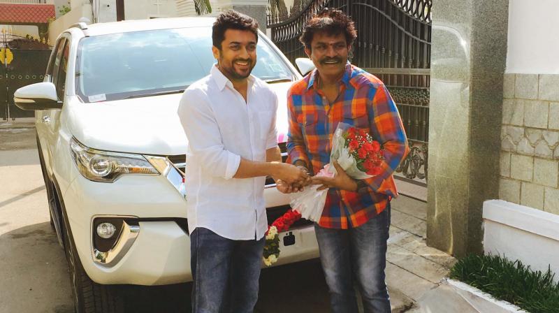 Suriya presenting Toyota Fortuner to Hari