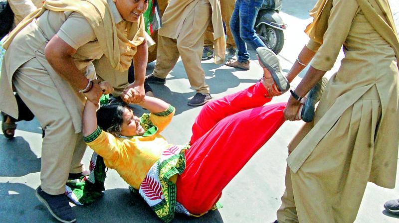 Students protesting at RTC Crossroads are taken into custody by police on Wednesday. (Photo: DC)