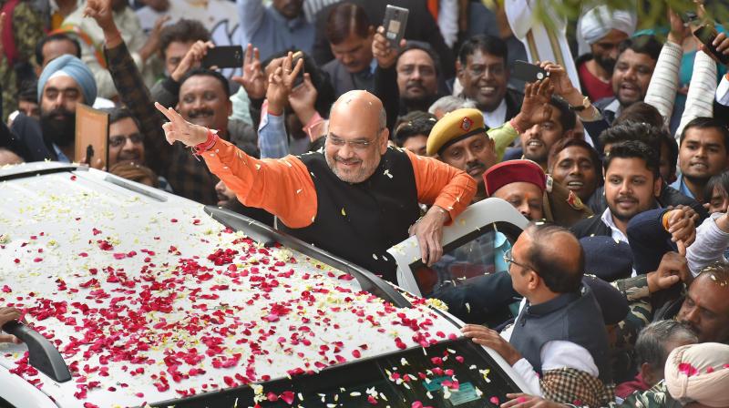 BJP President Amit Shah gestures while being welcomed on his arrival at the party headquarters in New Delhi on Monday, after the partys victory in the Assembly elections in Gujarat and Himachal Pradesh. (Photo: PTI)