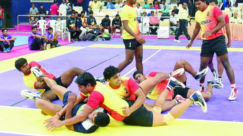 Andhra Pradesh players pin down their rival from Chhattisgarh on way to a 44-43 victory.