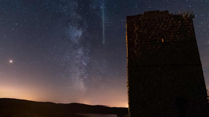 A meteor crosses the night sky next to the milky way, early August 12, 2018 in Pierre-Percee lake area, eastern France, during the annual Perseid meteor shower night.(Photo: AFP)