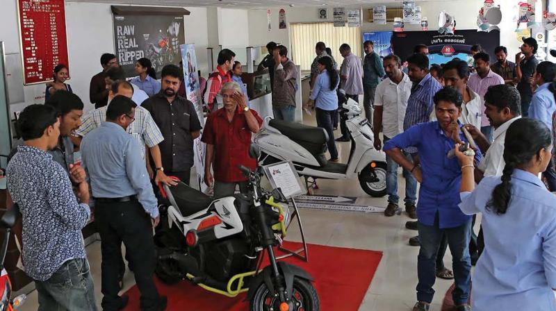 Avid buyers at a two-wheeler dealer shop in Kochi on Friday, hoping to cash in on desperate sales on the eve of the new financial year (Photo: DC) Avid buyers at a two-wheeler dealer shop in Kochi on Friday, hoping to cash in on desperate sales on the eve of the new financial year (Photo: DC)