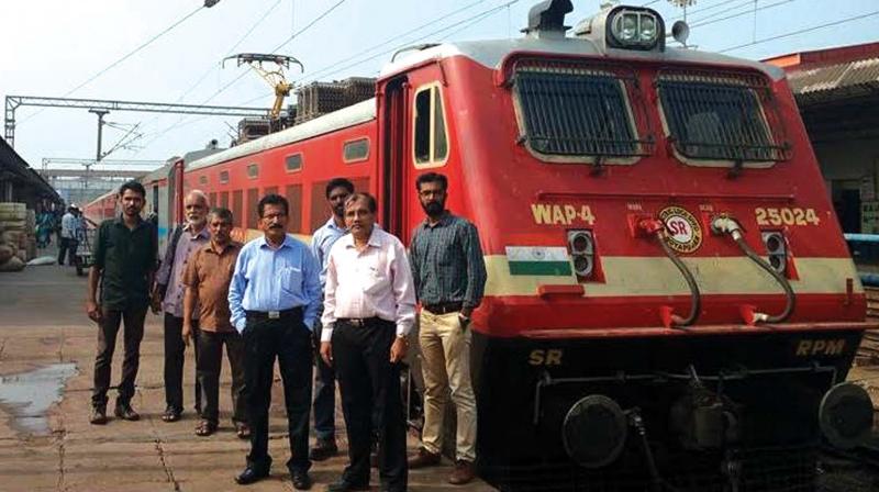 Railway officials pose alongside Chennai Central-Mangaluru Super fast express which ran with AC loco, in Mangaluru on Friday. (Photo: DC)