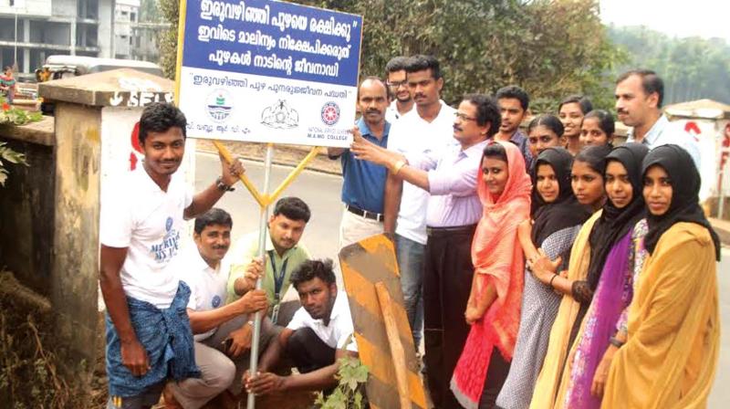 CWRDM scientist Dr Madhavan Komath inaugurates the sign board installation  programme at Iruvanjippuzha riverside.