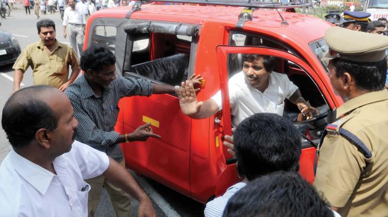 Workers of various trade unions block a private vehicle during the vehicle strike in Thiruvananthapuram on Friday. (Photo: A.V. MUZAFAR)
