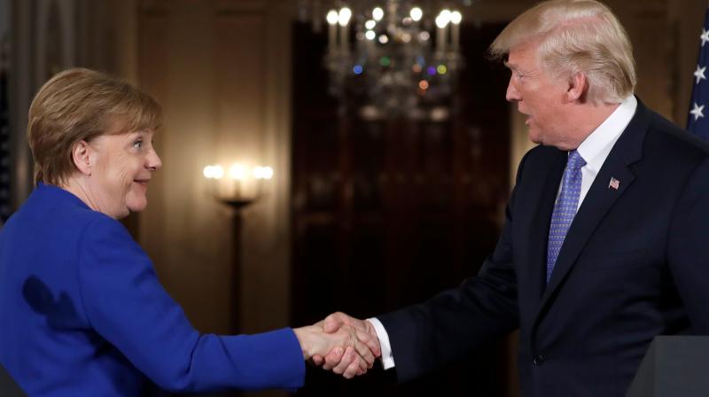 President Donald Trump shakes hands with German Chancellor Angela Merkel at the end of their news conference in the East Room of the White House, Friday. (Photo: AP)