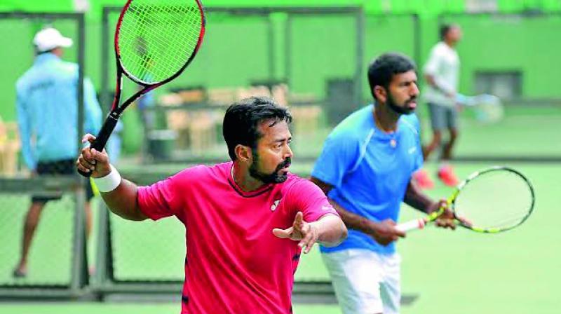 Leander Paes and Rohan Bopanna at a training session in Bengaluru on Wednesday, ahead of their Davis Cup Group I tie against Uzbekistan beginning Friday.(Photo: SHASHIDHAR B)