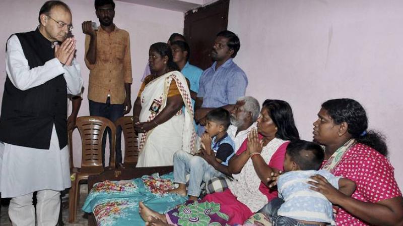 Thiruvananthapuram : Union Finance Minister Arun Jaitley visiting the family members of slain RSS worker Rajesh Edavakode who was brutally killed last week allegedly by a group of CPI(M) supporters, in Thiruvananthapuram on Sunday. (Photo: PTI)
