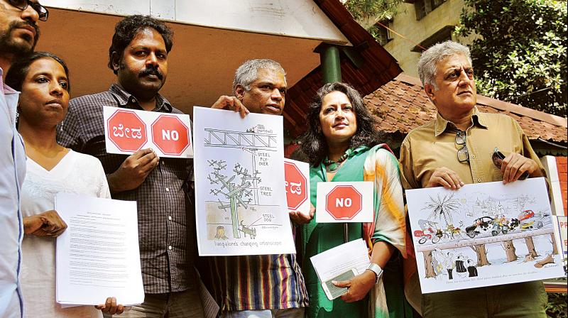 Prakash Belawadi (2nd L), Priya Rajgopal Chetty, Naresh Narasimhan and other volunteers at a press meet against the steel flyover in Bengaluru on Monday. (Photo: DC)