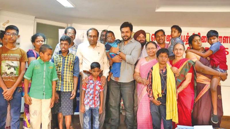 Actor Karthi Sivakumar along with children suffering from Lysosomal Storage Disorders and their families at an event in Press Club, on Tuesday.	(Photo: DC)